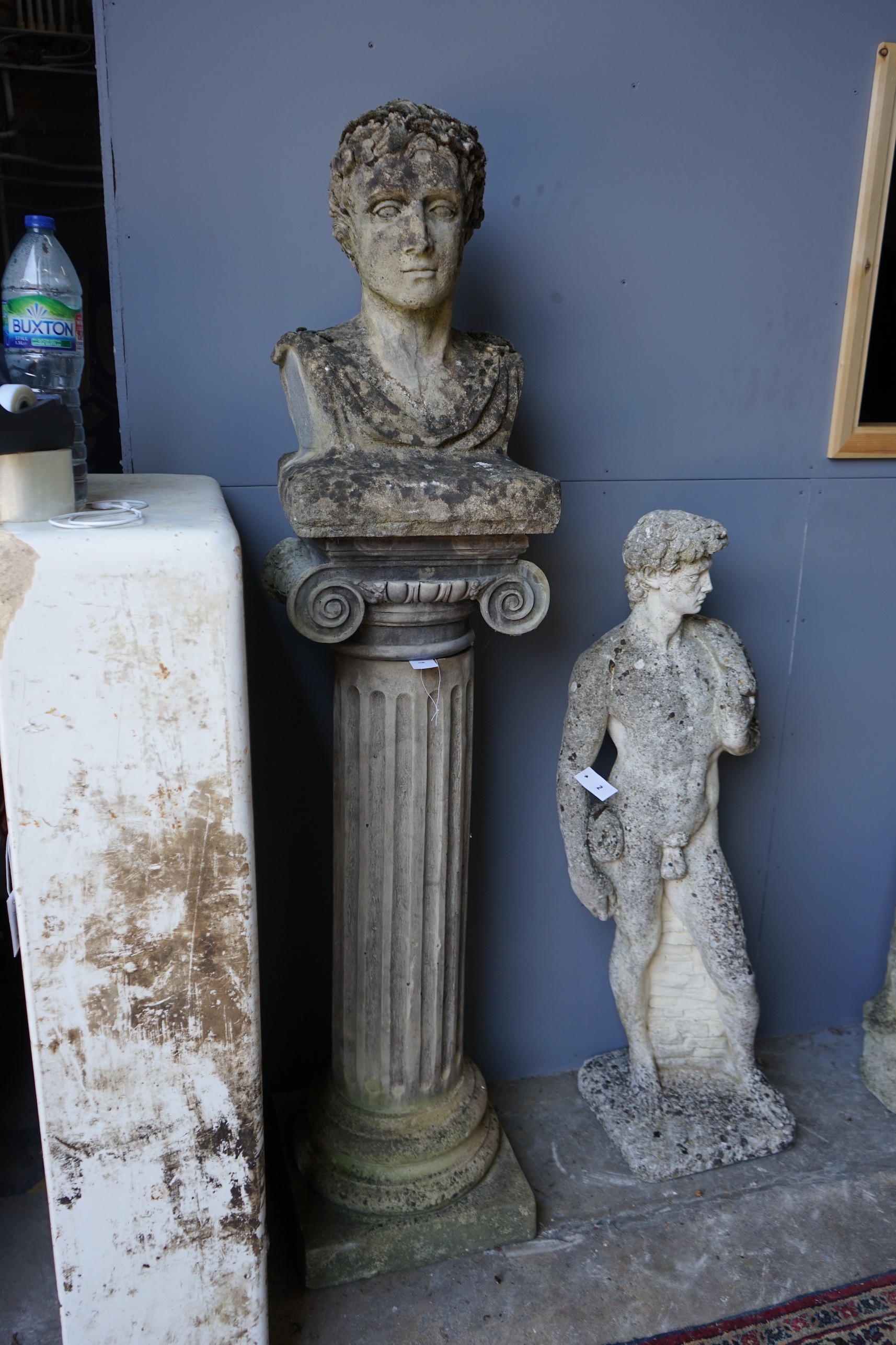 A reconstituted stone bust of a Roman emperor on fluted ionic column, height 172cm